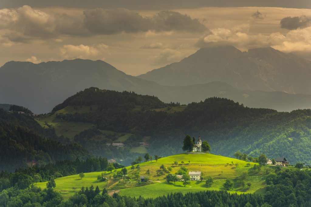 Landmark Church Stand Out at Hilltop in Julian Alps Landscape. Sveti Tomaz in Skofja Loka Slovenia